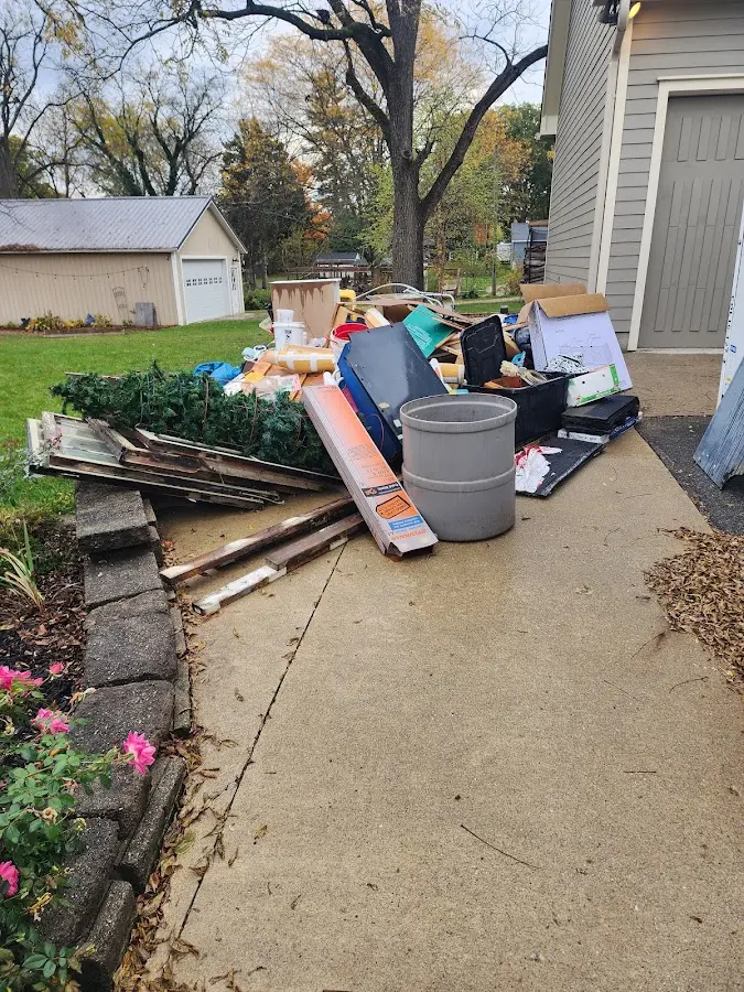 Dumpster being loaded with debris for Estate Cleanout Dumpster Rental in Pass Christian